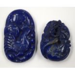 TWO ORIENTAL CARVED LAPIS PLAQUES. (2)