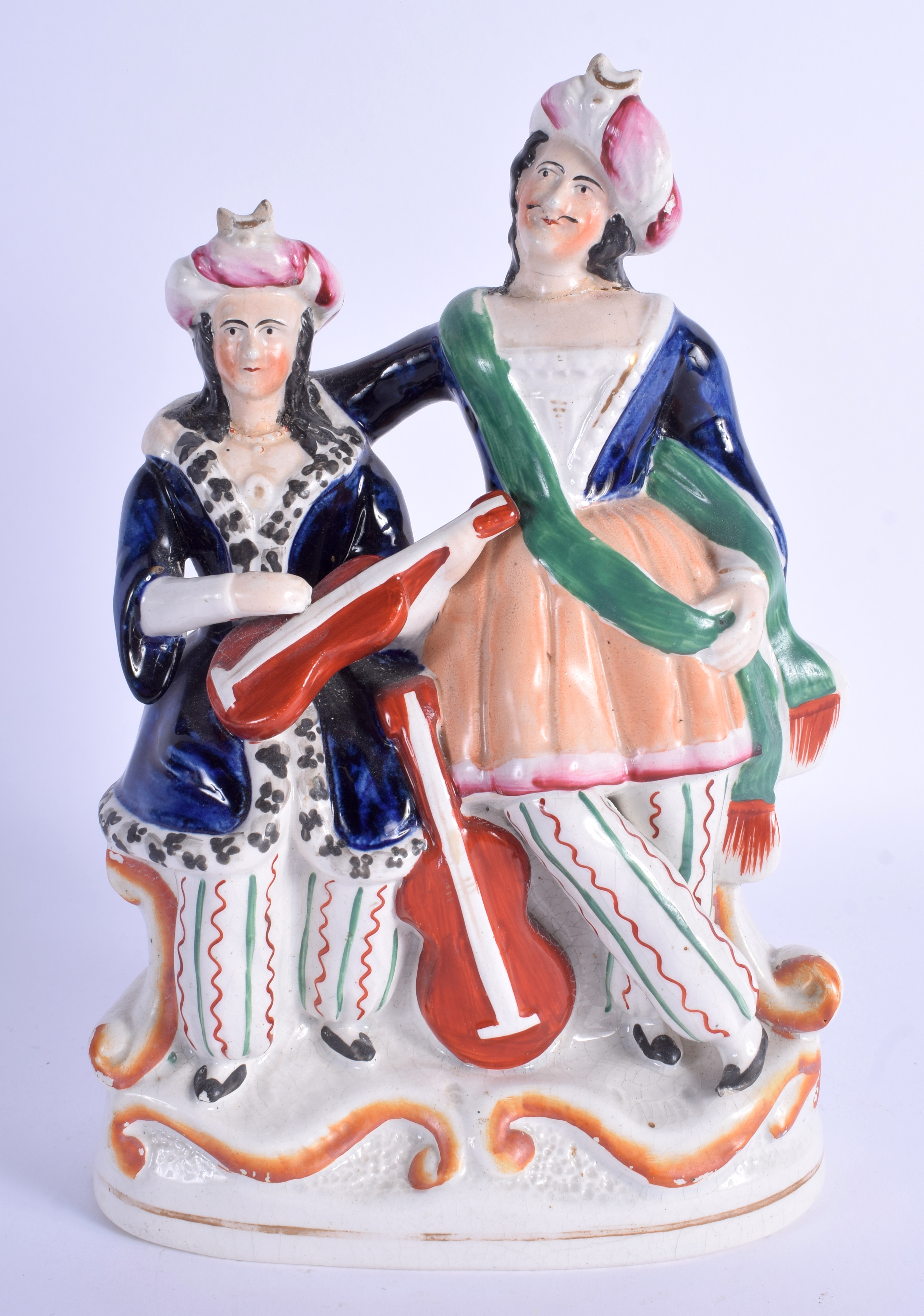 A 19TH CENTURY STAFFORDSHIRE FIGURE OF TWO TURKISH MUSICIANS depicting a Sultan & Sultane. 24 cm x 1