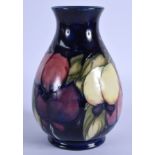 A MOORCROFT VASE decorated with berries. 16 cm high.