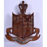 AN UNUSUAL VINTAGE CARVED WOOD MAURITIUS POLICE CRESTED PANEL. 23 cm x 27 cm.