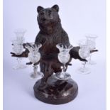 A 19TH CENTURY BAVARIAN BLACK FOREST LIQUOR GLASS HOLDER formed as a standing bear. 35 cm x 19 cm.