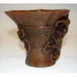 A CHINESE CARVED BUFFALO HORN LIBATION CUP. 13 cm high.