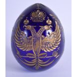 AN EARLY 20TH CENTURY RUSSIAN GILDED BOHEMIAN BLUE EGG decorated with a eagles. 11 cm x 6.5 cm.