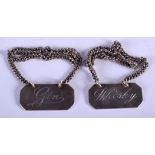 A PAIR OF VINTAGE SILVER DECANTER LABELS. 3 cm cm x 1.25 cm.