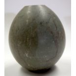 A MIDDLE EASTERN STONE ORB. 18 cm high.