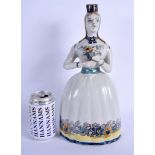 A LARGE AND UNUSUAL19TH CENTURY FRENCH FAIENCE LIQUOR DECANTER modelled holding flowers. 34 cm x 14