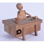 A 19TH CENTURY JAPANESE MEIJI PERIOD CARVED WOOD KOBE TOY modelled as an artisan. 13 cm x 8.5 cm.