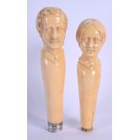 A PAIR OF 19TH CENTURY CONTINENTAL CARVED IVORY PARASOL HANDLES in the form of a male and female. 13