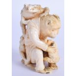 A 19TH CENTURY JAPANESE MEIJI PERIOD CARVED IVORY OKIMONO modelled as a monkey with toads upon his b
