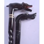 TWO EARLY 20TH CENTURY CONTINENTAL EBONISED WALKING CANES with spiral twisted columns. 90 cm long. (