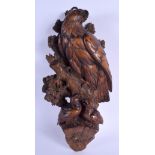 A 19TH CENTURY BAVARIAN BLACK FOREST CARVED WOOD EAGLE WALL PLAQUE formed with a mother over two fee
