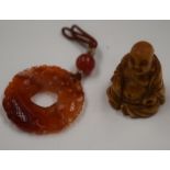 AN EARLY 20TH CENTURY CHINESE AGATE PENDANT together with a buddha. (2)