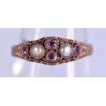 A VICTORIAN 14CT GOLD RUBY AND PEARL RING. 1.8 grams. N.