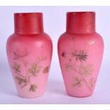 A PAIR OF EDWARDIAN PINK AND WHITE OPALINE GLASS VASES decorated with gilt foliage. 15.5 cm high.