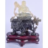 AN EARLY 20TH CENTURY CHINESE CARVED JADE FIGURE OF A BUDDHISTIC DEITY modelled upon a lion. Jade 13