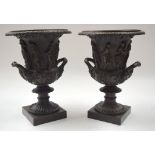 A LARGE PAIR OF TWIN HANDLED BRONZE PEDESTAL URNS decorated with figures. 30 cm x 18 cm.