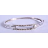 A 9CT WHITE GOLD BANGLE. 8.7 grams. 5.5 cm wide.