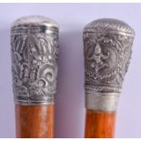 A 19TH CENTURY CHINESE SILVER MOUNTED MALACCA WALKING CANE together with another silver topped cane.