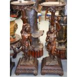 A PAIR OF ANTIQUE ITALIAN CARVED WOOD PEDESTAL FIGURAL STANDS formed as maidens. 110 cm x 36 cm.