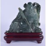 A 1930S CHINESE CARVED JADEITE FIGURE OF A WARRIOR modelled holding his sword. Jadeite 11 cm x 9 cm.