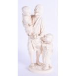 A 19TH CENTURY JAPANESE MEIJI PERIOD CARVED IVORY OKIMONO modelled as a father with two children. 19