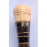 A RARE 19TH CENTURY CARVED IVORY MULTI SECTIONAL HORN CANE of facetted form. 78 cm long.