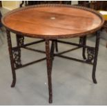 A RARE 19TH CENTURY CHINESE CARVED HONGMU CIRCULAR TABLE ON STAND Qing, with folding naturalistic vi
