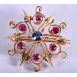 A GOLD RUBY AND AND SAPPHIRE BROOCH. 5.9 grams. 3 cm wide.
