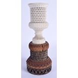 A 19TH CENTURY ANGLO INDIAN CARVED IVORY AND NUT VASE of geometric form. 23 cm high.
