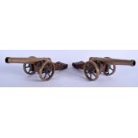 A PAIR OF 19TH CENTURY BRASS AND BRONZE SIGNAL CANNONS upon carved wood bases. 22 cm wide.