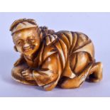 A 19TH CENTURY JAPANESE MEIJI PERIOD CARVED IVORY NETSUKE depicting ebisu crouching a fish. 4.5 cm x