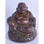 A 19TH CENTURY CHINESE BRONZE FIGURE OF A SEATED BUDDHA Qing, modelled holding a peach upon a lotus