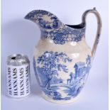 AN EARLY 19TH CENTURY STAFFORDSHIRE BLUE AND WHITE POTTERY JUG. 26 cm high.