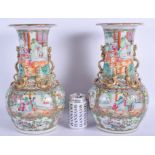 A LARGE PAIR OF 19TH CENTURY CHINESE CANTON FAMILLE VASES Qing, painted with figures and overlaid wi