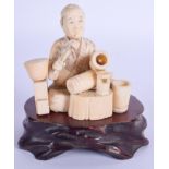 A 19TH CENTURY JAPANESE MEIJI PERIOD CARVED IVORY OKIMONO modelled as a seated artisan. Ivory 8 cm x