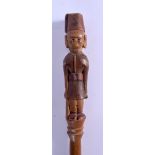 A LARGE EARLY 20TH CENTURY AFRICAN COLONIAL CARVED WOOD TRIBAL STAFF of figural form. 150 cm long.