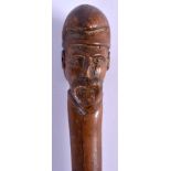 A 19TH CENTURY CONTINENTAL CARVED FRUITWOOD WALKING CANE with moustached male terminal. 90 cm long.