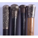 FOUR ANTIQUE SILVER MOUNTED WALKING CANES in various forms and sizes. Longest 90 cm long. (4)