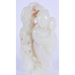 AN EARLY 20TH CENTURY CHINESE CARVED PALE WHITE JADE FIGURE Qing, modelled holding a floral sprig. 1