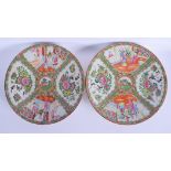 A PAIR OF EARLY 20TH CENTURY CHINESE CANTON FAMILLE ROSE DISHES painted with landscapes. 30 cm diame