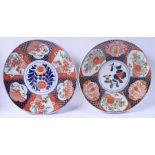 A PAIR OF 19TH CENTURY JAPANESE MEIJI PERIOD IMARI CHARGERS painted with foliage. 30 cm diameter.