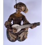 A LARGE MID 19TH CENTURY PAINTED TERRACOTTA DUTCH HANGING FIGURE modelled as a female playing an ins