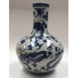 A LARGE CHINESE BLUE AND WHITE VASE probably late Qing, painted with dragons. 50 cm high.