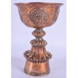 A 19TH CENTURY CHINESE TIBETAN COPPER LIBATION CUP decorated with buddhistic motifs. 18 cm x 9 cm.