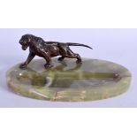 A 1920S FRENCH BRONZE AND ONYX ASHTRAY formed with a roaming tiger. 25 cm wide.
