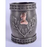 AN UNUSUAL 19TH CENTURY CONTINENTAL SILVER METAL MARRIAGE MUG with cast leaf work rims enclosing joi