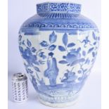 A LARGE EARLY 18TH CENTURY JAPANESE EDO PERIOD BLUE AND WHITE VASE painted with a scholar amongst fl