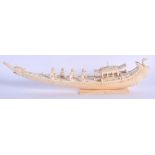 A 19TH CENTURY ANGLO INDIAN CARVED IVORY BOAT decorated with figures and birds. 30 cm wide.