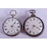 A GEORGE III PAIR CASED SILVER POCKET WATCH together with another. 5.5 cm wide. (2)