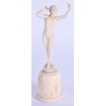 A MINIATURE ART NOUVEAU CARVED IVORY NUDE FEMALE modelled upon a shaped base. 9.5 cm high.